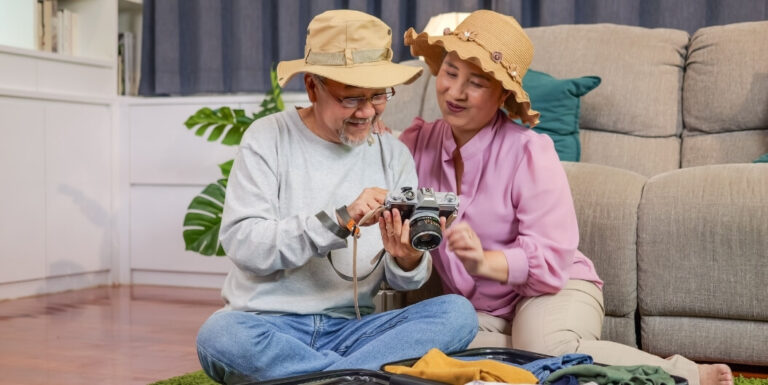 Elderly Couple Looking at Vintage Camera in Memory Care