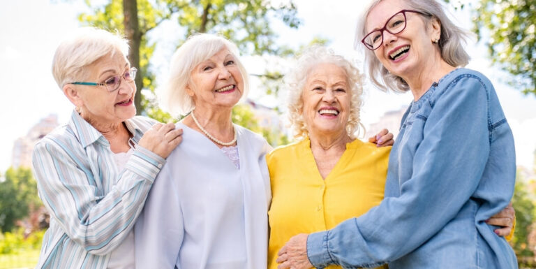 Elderly Women Laughing Together Outdoors at Independent Living Facility